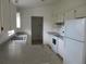 Efficient kitchen with white cabinets, appliances, and tile floor at 1073 Marcus St, Port Charlotte, FL 33952