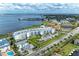 Expansive aerial view showcasing a modern condo building with lush landscaping and waterfront access at 1425 Park Beach Cir # 149, Punta Gorda, FL 33950