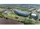 Beautiful aerial view featuring modern condos with a pool, lush landscaping, and a waterfront location at 1425 Park Beach Cir # 149, Punta Gorda, FL 33950