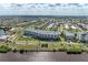 Wide aerial view of condos by a waterfront, showcasing lush landscaping and surrounding residential area at 1425 Park Beach Cir # 149, Punta Gorda, FL 33950