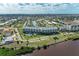 Extensive aerial shot of condos near water with surrounding residential areas, lush landscape and community pool at 1425 Park Beach Cir # 149, Punta Gorda, FL 33950