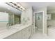 Elegant bathroom with double vanity, marble countertops, soaking tub, and a glass shower at 1425 Park Beach Cir # 149, Punta Gorda, FL 33950