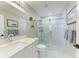 Modern bathroom with marble tiled shower and single vanity with a white countertop at 1425 Park Beach Cir # 149, Punta Gorda, FL 33950