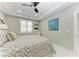 Bright bedroom featuring tray ceilings, shuttered windows, and stylish patterned bedding at 1425 Park Beach Cir # 149, Punta Gorda, FL 33950