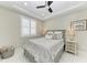 Bedroom featuring tray ceilings, shuttered windows, and stylish gray patterned bedding at 1425 Park Beach Cir # 149, Punta Gorda, FL 33950