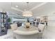 Elegant dining area with modern chandelier, luxury seating and views of the waterfront and surrounding landscape at 1425 Park Beach Cir # 149, Punta Gorda, FL 33950