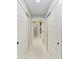 Hallway featuring white marble floors and double-door closets with modern black hardware at 1425 Park Beach Cir # 149, Punta Gorda, FL 33950