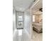 Bright, modern hallway with sleek tile flooring, opening to a cozy bedroom and a balcony door at 1425 Park Beach Cir # 149, Punta Gorda, FL 33950