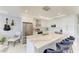 Bright kitchen with quartz countertops, modern pendant lights, stainless steel appliances and wine racks at 1425 Park Beach Cir # 149, Punta Gorda, FL 33950