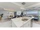 Modern kitchen with a quartz island overlooking the dining and living areas with water views at 1425 Park Beach Cir # 149, Punta Gorda, FL 33950