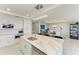 Bright kitchen featuring a quartz island, modern lighting, stainless steel appliances, and dining area at 1425 Park Beach Cir # 149, Punta Gorda, FL 33950