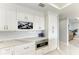Bright kitchen featuring a microwave, wine rack, white cabinetry and quartz countertops at 1425 Park Beach Cir # 149, Punta Gorda, FL 33950