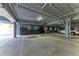 Well-lit parking garage with marked spaces and storage units, ensuring convenience and security at 1425 Park Beach Cir # 149, Punta Gorda, FL 33950