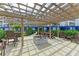 Community pergola featuring outdoor seating, lush landscaping and blue facade in the background at 1425 Park Beach Cir # 149, Punta Gorda, FL 33950