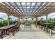 Inviting outdoor pergola area with picnic tables and grill provides scenic bay views at 1425 Park Beach Cir # 149, Punta Gorda, FL 33950