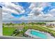 This aerial shot captures a resort style pool, a lush yard, and bay views at 1425 Park Beach Cir # 149, Punta Gorda, FL 33950