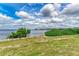 Tranquil waterfront view with lush greenery and a bench, offering a peaceful spot to enjoy the scenery at 1425 Park Beach Cir # 149, Punta Gorda, FL 33950