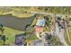 Aerial view of community pool, pond, and clubhouse at 15292 Mille Fiore Blvd, Port Charlotte, FL 33953