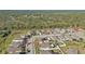 Wide aerial view of a residential neighborhood, showcasing numerous houses and surrounding landscape at 15292 Mille Fiore Blvd, Port Charlotte, FL 33953