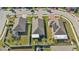 Aerial view of two houses with screened-in patios, showcasing their backyard spaces at 15292 Mille Fiore Blvd, Port Charlotte, FL 33953