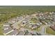 Wide aerial view of a residential neighborhood, showcasing numerous houses and surrounding landscape at 15292 Mille Fiore Blvd, Port Charlotte, FL 33953