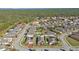 Wide aerial view of a residential neighborhood, showcasing numerous houses and surrounding landscape at 15292 Mille Fiore Blvd, Port Charlotte, FL 33953