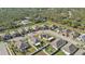 Aerial view of a residential neighborhood showcasing houses with solar panels and nicely landscaped yards at 15292 Mille Fiore Blvd, Port Charlotte, FL 33953