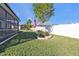 Fenced backyard with American flag and landscaping at 15292 Mille Fiore Blvd, Port Charlotte, FL 33953
