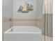 Clean bathroom, featuring a bathtub and nautical-themed decor at 15292 Mille Fiore Blvd, Port Charlotte, FL 33953