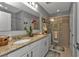 Elegant bathroom with granite countertops and a walk-in shower at 15292 Mille Fiore Blvd, Port Charlotte, FL 33953