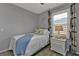 Serene bedroom with white metal bed frame and window seat at 15292 Mille Fiore Blvd, Port Charlotte, FL 33953