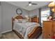Cozy bedroom with wooden bed frame and dresser at 15292 Mille Fiore Blvd, Port Charlotte, FL 33953