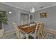 Dining room with a wood table, chandelier, and access to the entryway at 15292 Mille Fiore Blvd, Port Charlotte, FL 33953