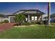 Single-story home with gray siding, brick pavers, and palm trees at 15292 Mille Fiore Blvd, Port Charlotte, FL 33953