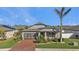 One-story home with brick paver driveway, screened-in garage, and landscaped yard at 15292 Mille Fiore Blvd, Port Charlotte, FL 33953