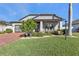 Curb appeal of the home with landscaping, brick driveway, and porch at 15292 Mille Fiore Blvd, Port Charlotte, FL 33953