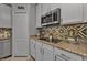 Kitchen with granite countertops and pantry at 15292 Mille Fiore Blvd, Port Charlotte, FL 33953