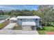 Aerial view of house with deck, carport, and fenced yard at 1931 Bayshore Dr, Englewood, FL 34223