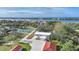 Aerial view of house, outbuildings, pickleball court, and waterfront at 1931 Bayshore Dr, Englewood, FL 34223