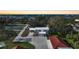 Aerial view of house, outbuildings, pickleball court, and waterfront at 1931 Bayshore Dr, Englewood, FL 34223