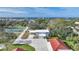 Aerial view of house, outbuildings, pickleball court, and waterfront at 1931 Bayshore Dr, Englewood, FL 34223