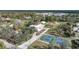 Aerial view of property with house, outbuildings, and pickleball court at 1931 Bayshore Dr, Englewood, FL 34223
