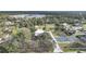 Aerial view showing house, outbuildings, and pickleball court near water at 1931 Bayshore Dr, Englewood, FL 34223