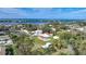 Aerial view showing house, outbuildings, and pickleball court near water at 1931 Bayshore Dr, Englewood, FL 34223