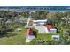 Aerial view of home, detached garages, and tennis court with water views at 1931 Bayshore Dr, Englewood, FL 34223