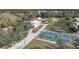 Aerial view showing home, pool, and large lot with pickleball court at 1931 Bayshore Dr, Englewood, FL 34223
