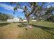 Large backyard with open space and a pink swing at 1931 Bayshore Dr, Englewood, FL 34223