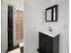 Simple bathroom with a vanity, medicine cabinet, and shower at 1931 Bayshore Dr, Englewood, FL 34223