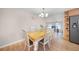 Bright dining room features a wood table with white chairs and a light-colored floor at 1931 Bayshore Dr, Englewood, FL 34223