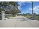 Gated entrance to property with long driveway at 1931 Bayshore Dr, Englewood, FL 34223